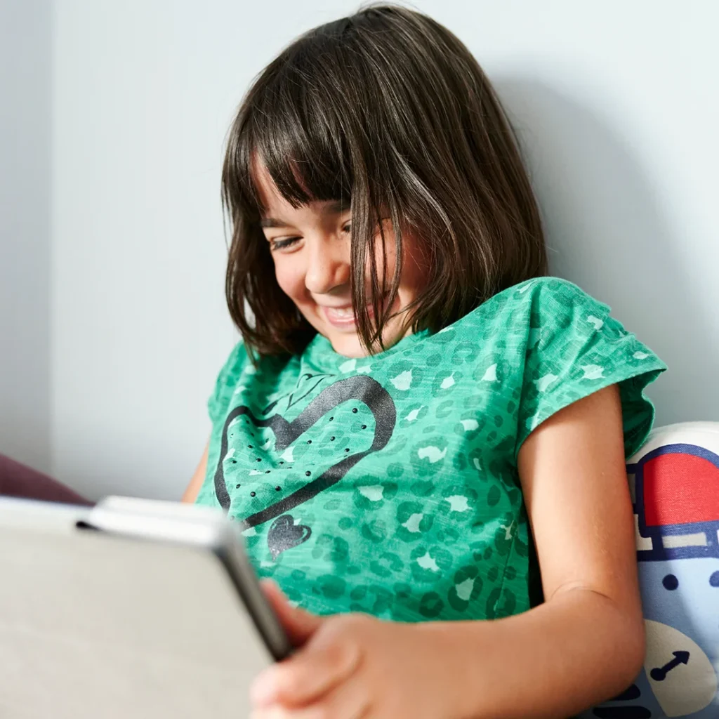 Girl with autism looking at ipad